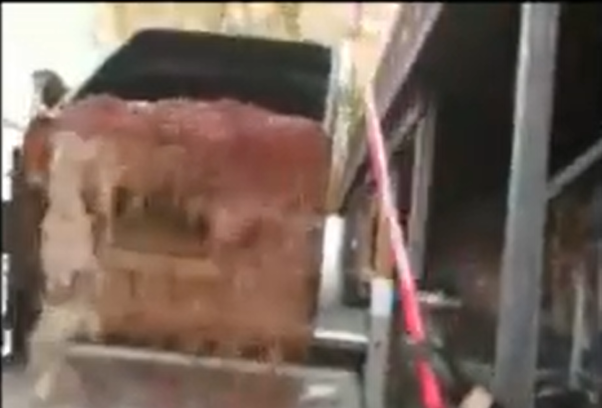 grape juice pouring out of bin
